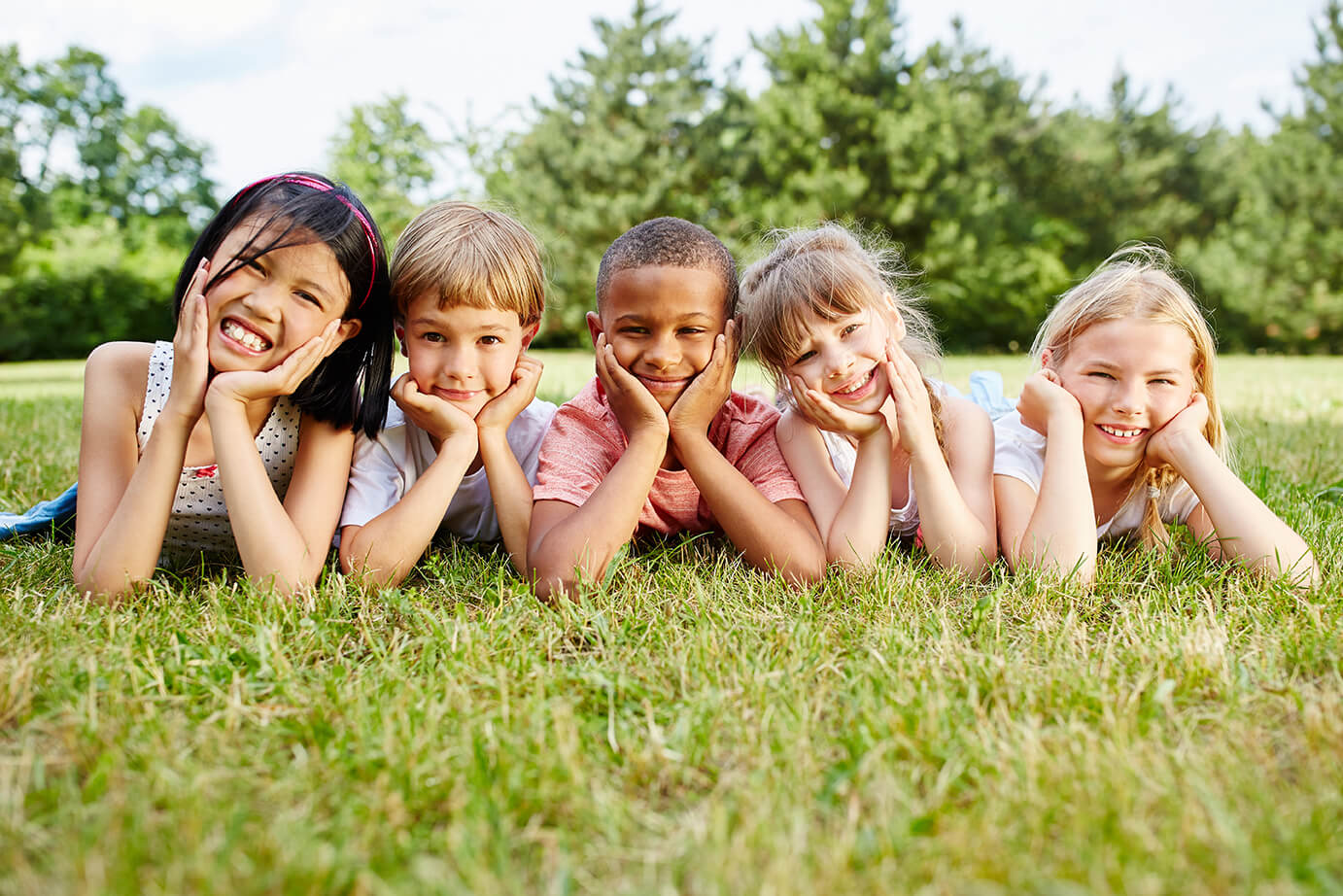 Children smiling on the grass